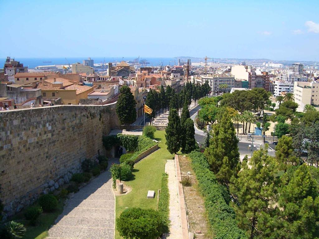 a view of a city with a wall and trees at Residencia Alclausell in Tarragona