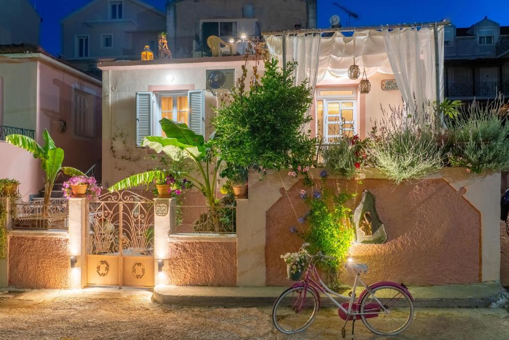 a bike parked in front of a house with plants at Flowers in the city - Elegant Home in Argostoli in Argostoli