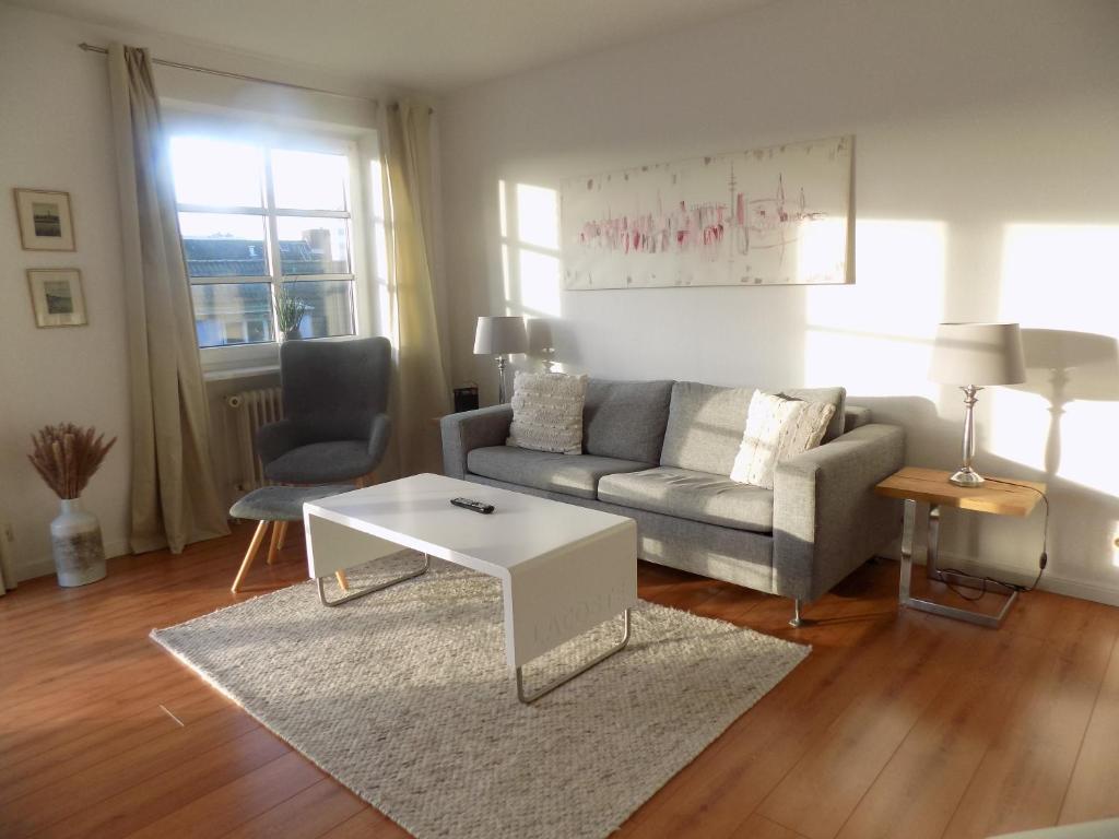 a living room with a couch and a coffee table at Sylter Apartments Wilhelmstrasse in Westerland