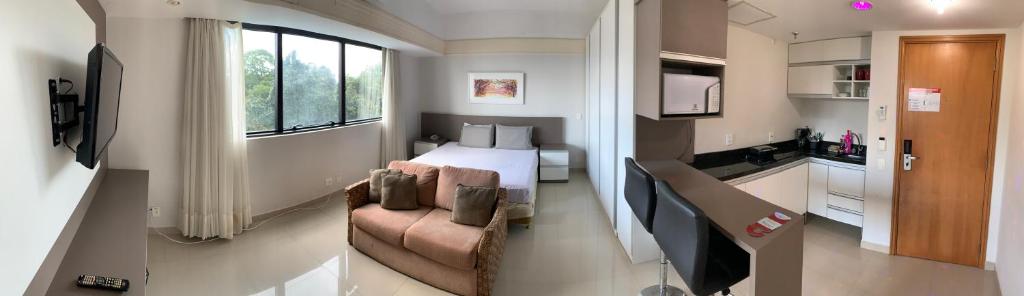 a small room with a bed and a kitchen at Tropical Executive Hotel in Manaus