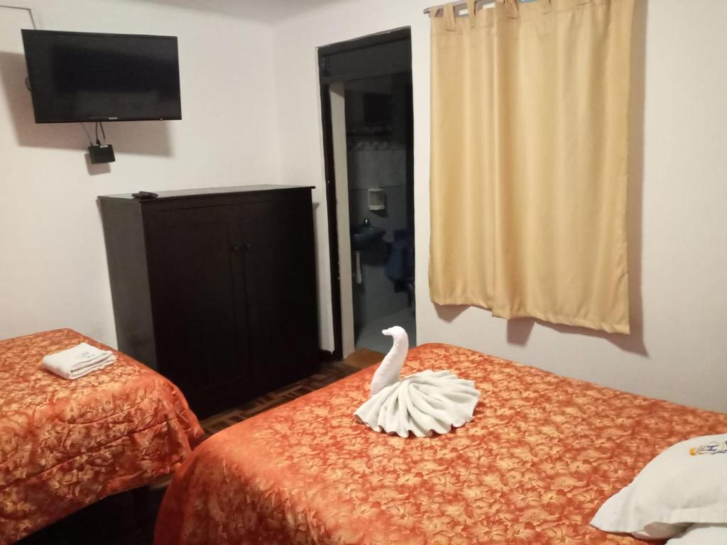 Ένα ή περισσότερα κρεβάτια σε δωμάτιο στο Qoricancha B&B Cusco