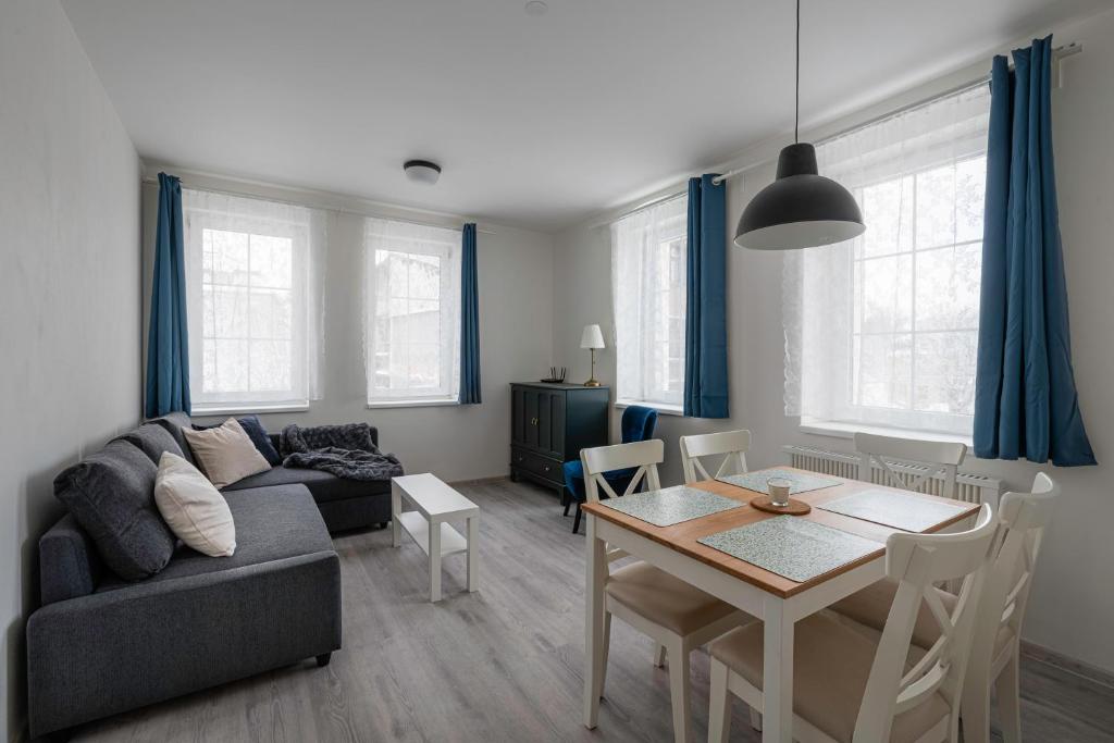 a living room with a couch and a dining room table at Marcebila Abertamy in Abertamy