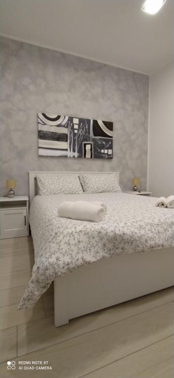 a bedroom with a white bed with a white comforter at Civico85 in Naples