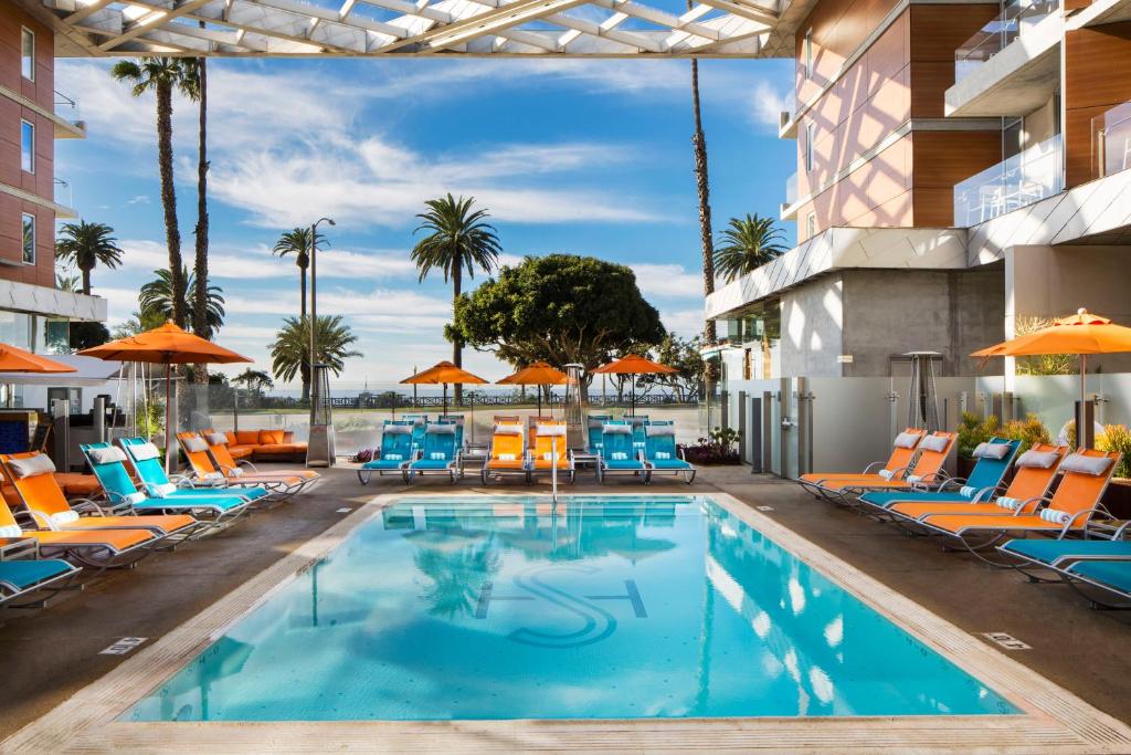 a pool at a hotel with chairs and umbrellas at Shore Hotel in Los Angeles