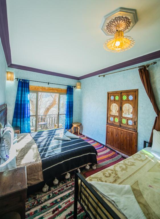 Postel nebo postele na pokoji v ubytování Dar Adrar