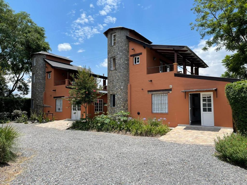 a house with a tower on top of it at Cabañas del Norte in San Lorenzo