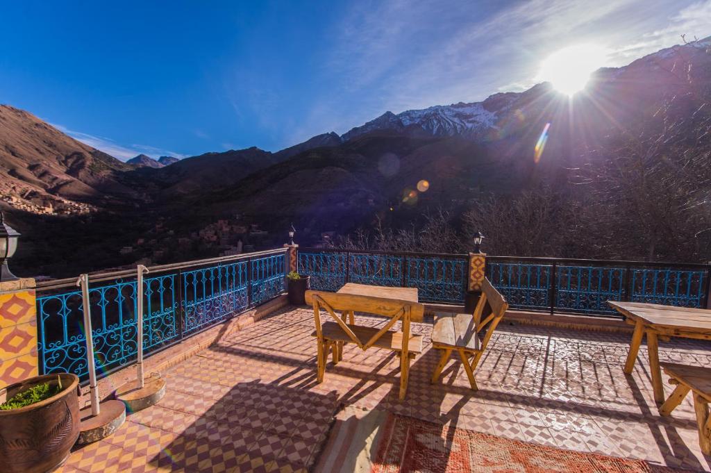 a balcony with a table and a view of a mountain at Dar Adrar in Imlil