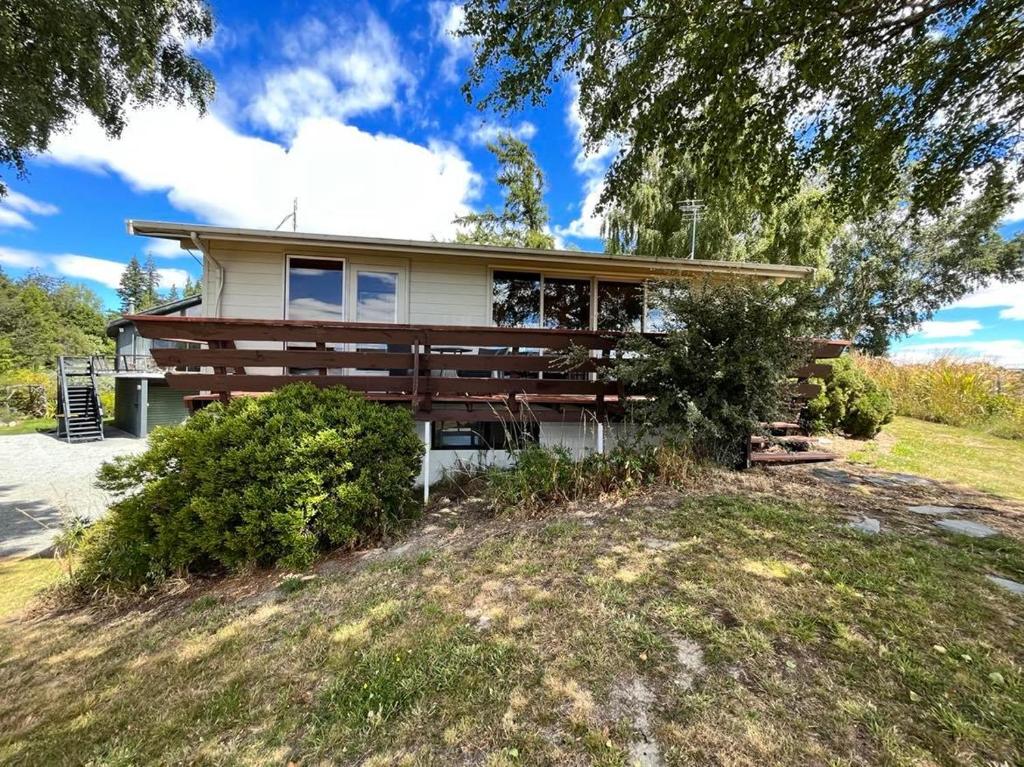 a house on a hill with a tree at Church House Beside the Lake in Lake Tekapo