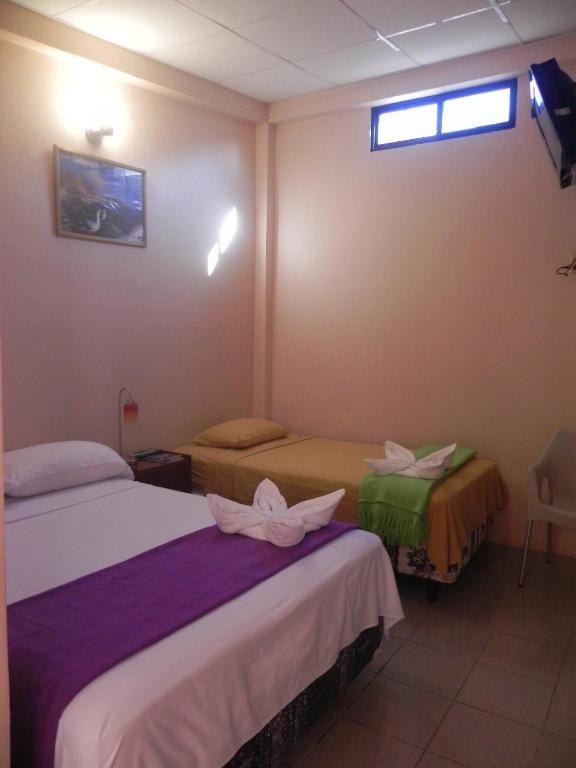 Postel nebo postele na pokoji v ubytování Hostal La Posada De Jose Carlos