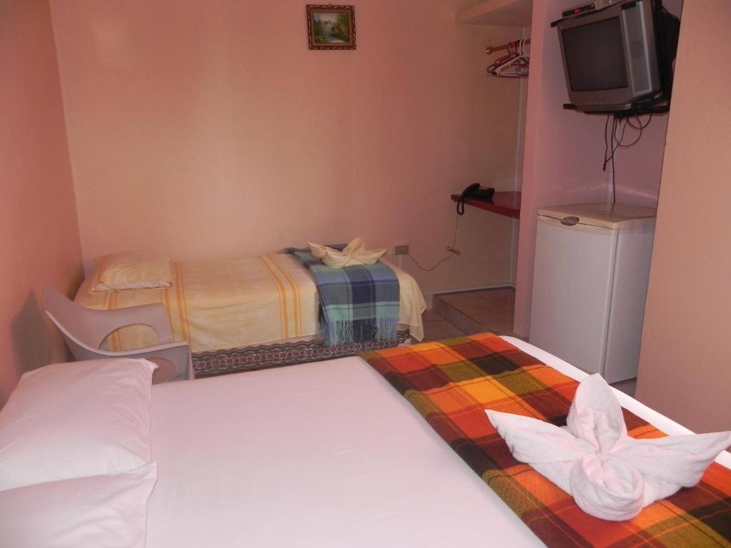 Postel nebo postele na pokoji v ubytování Hostal La Posada De Jose Carlos