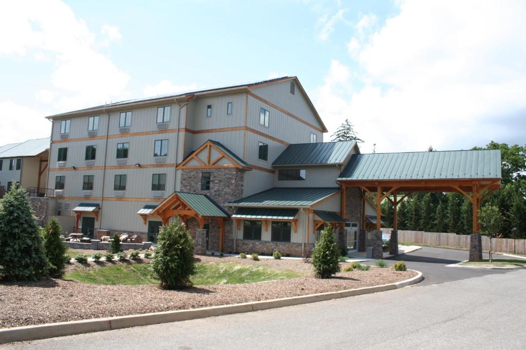 a large white building with a gambrel at Hotel Floyd in Floyd