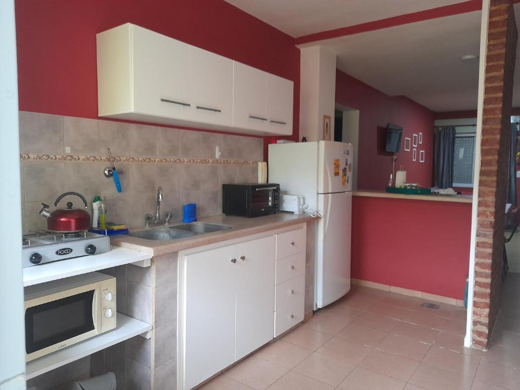 a kitchen with white cabinets and a white refrigerator at Departamento céntrico en San Pedro in San Pedro