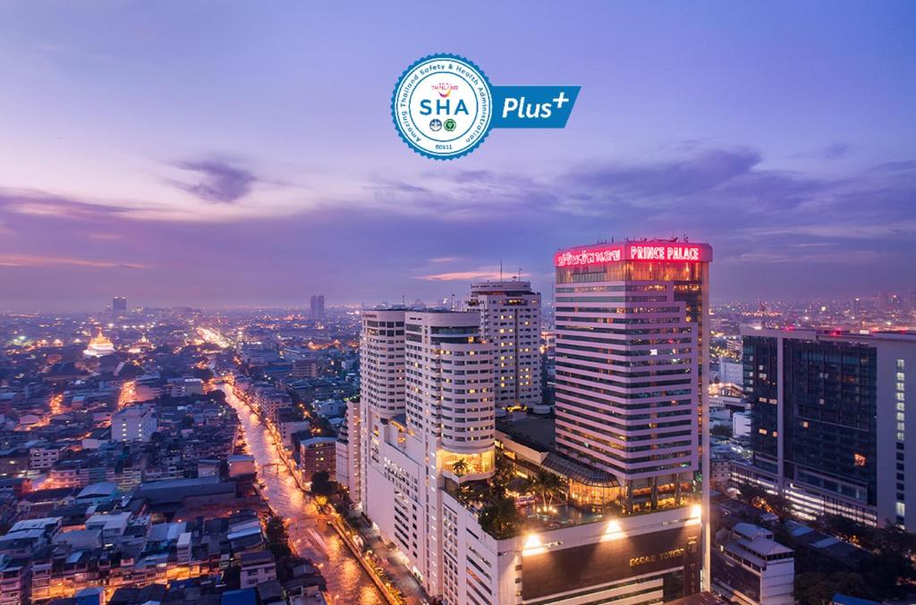 a city at night with a sign that says shk plus at Prince Palace Hotel Bangkok - SHA Extra Plus in Bangkok