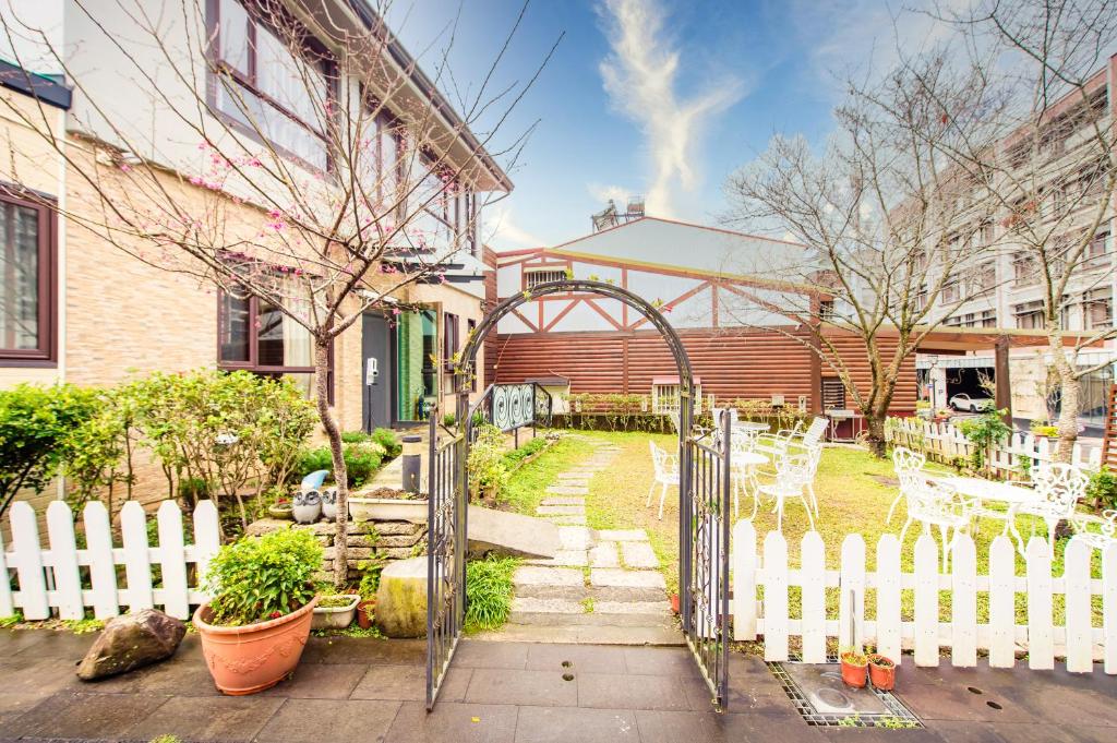 an open gate in a yard with a white fence at Moonlake B&amp;B in Yuchi