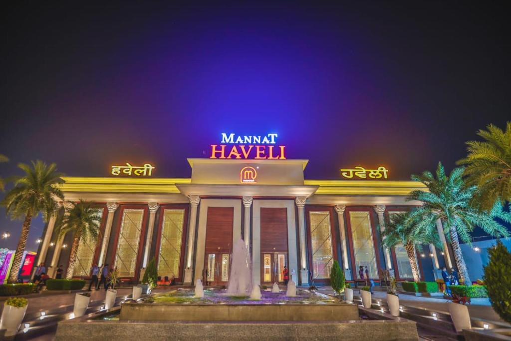 a building with a fountain in front of it at Mannat Haveli in Kurukshetra