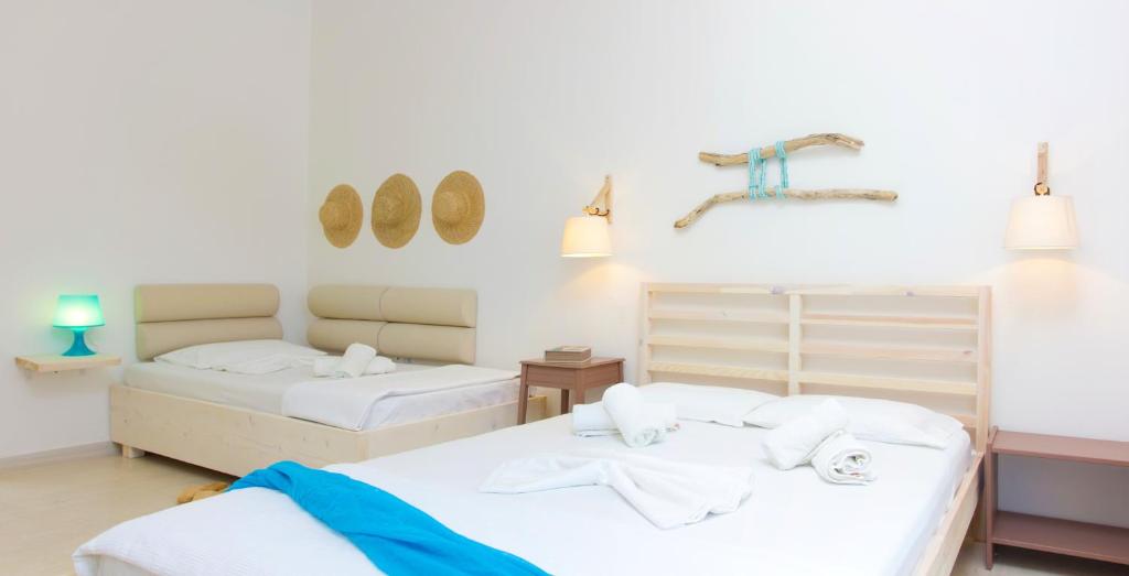 two beds in a room with white walls at Thetis in Alikanas