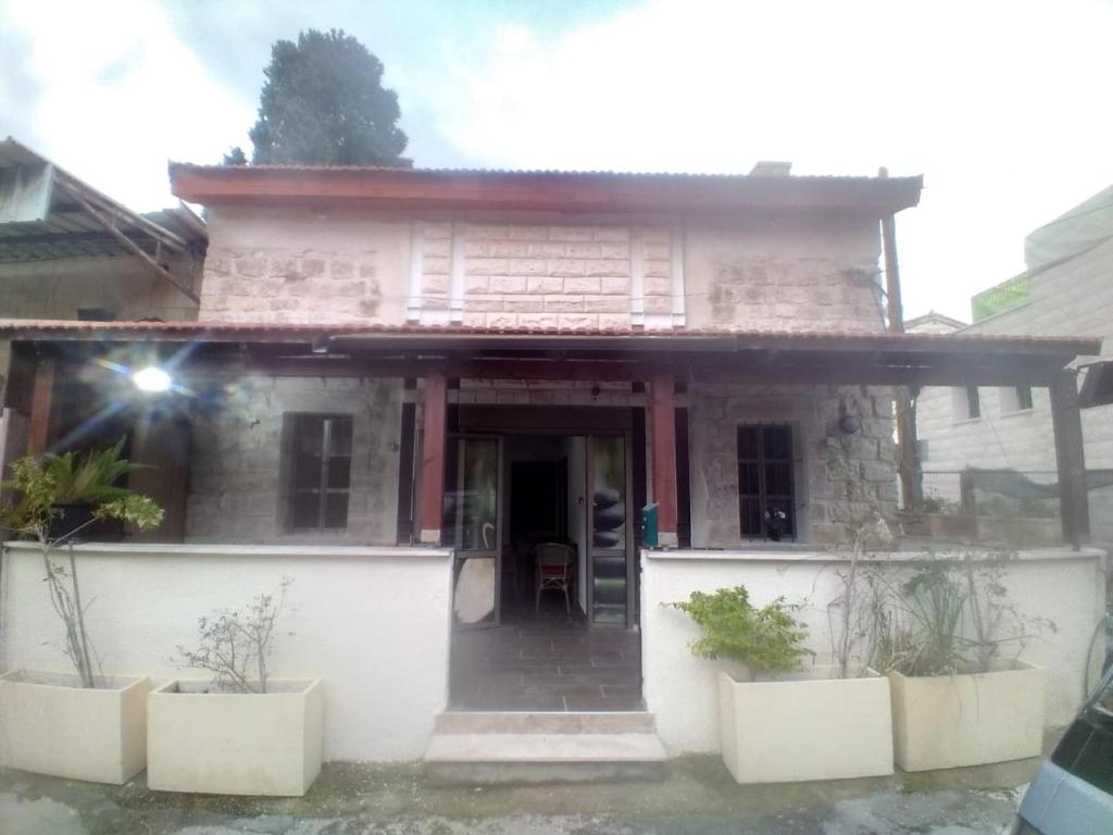 a small house with plants in front of it at BenGurion 25 Apartment in Haifa