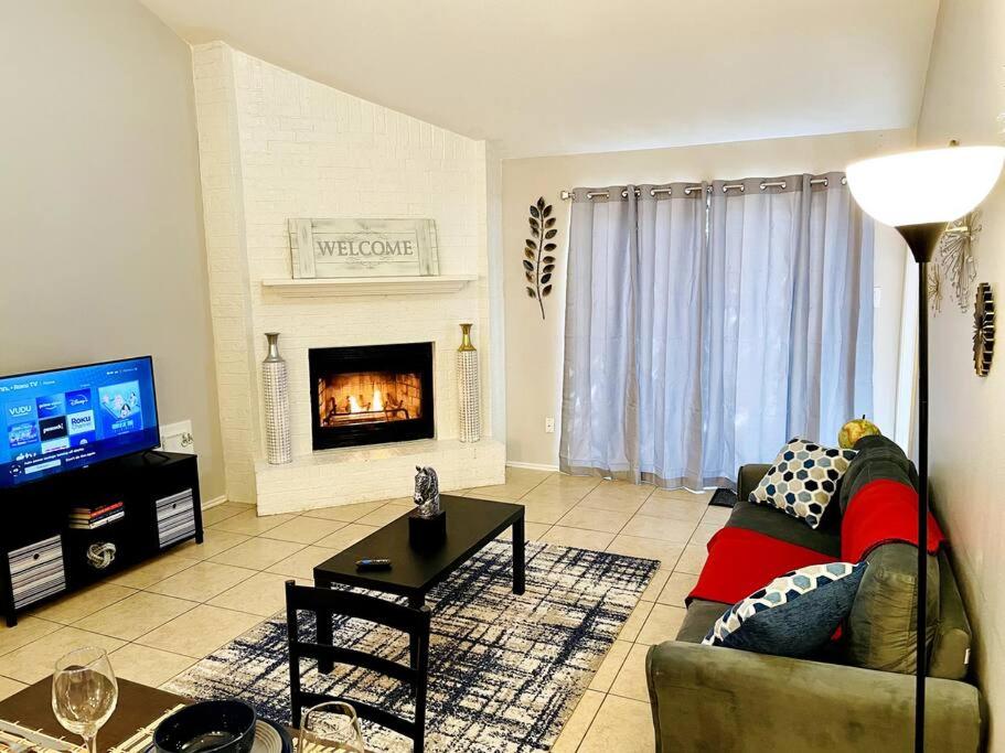 a living room with a couch and a fireplace at Cosy House - 3 Bed, 2 Baths in The Woodlands in The Woodlands