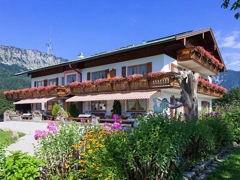 a large building with flowers in front of it at Gästehaus Marchler in Bischofswiesen