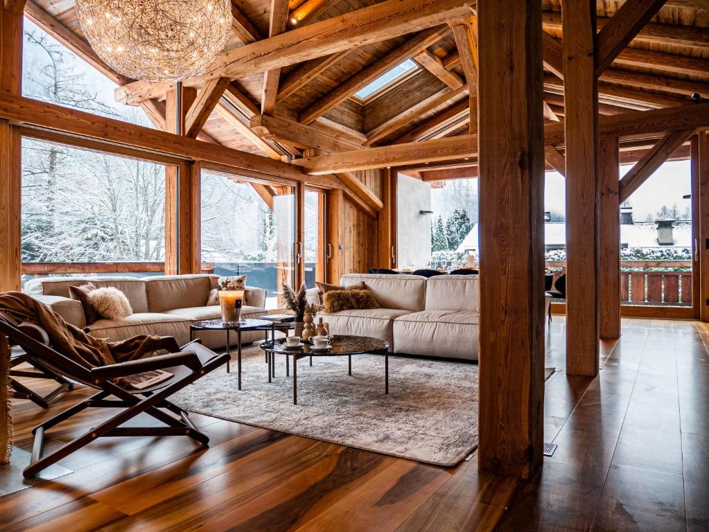 a living room with a couch and a table at Chalet Bonami - Chalet de Prestige à Chamonix in Chamonix