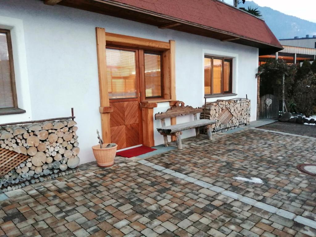 a house with a wooden door and a bench at Appartement Geisler in Fügen