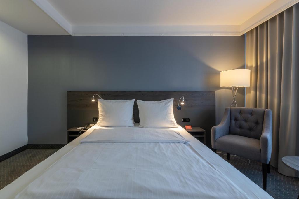 Postel nebo postele na pokoji v ubytování Lindgart Hotel Minden