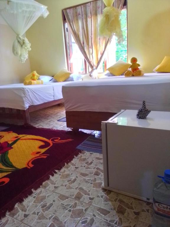 Postel nebo postele na pokoji v ubytování Flower Inn
