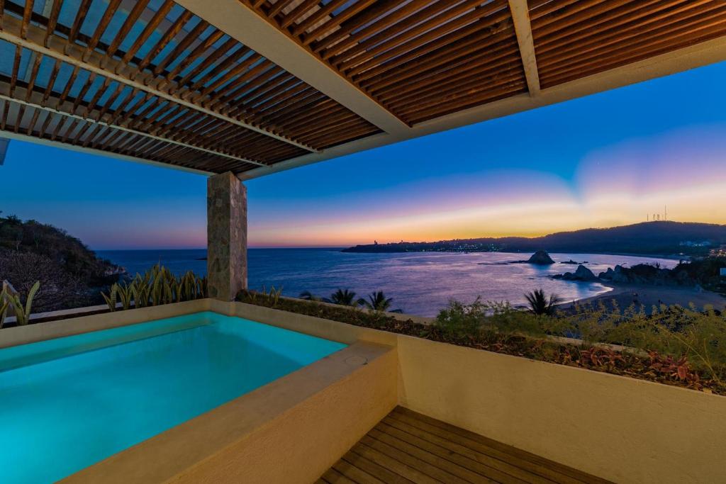 - une piscine dans une maison avec vue sur l'océan dans l'établissement 2061 - Lu Iba PH Condo 5, à Santa Cruz Huatulco