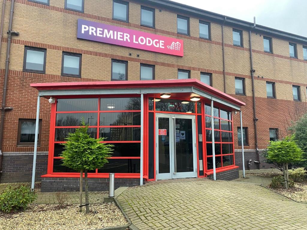 a red brick building with a sign on the side of it at Premier Lodge in Falkirk