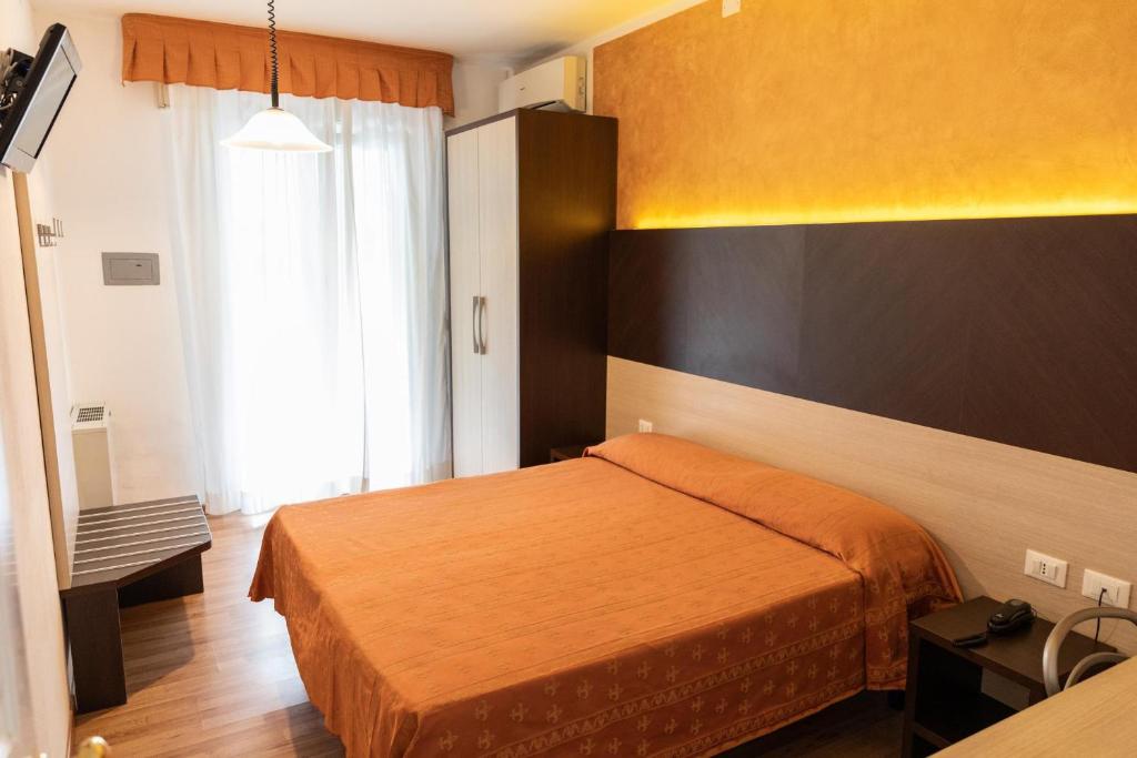 Postel nebo postele na pokoji v ubytování Hotel Verdi