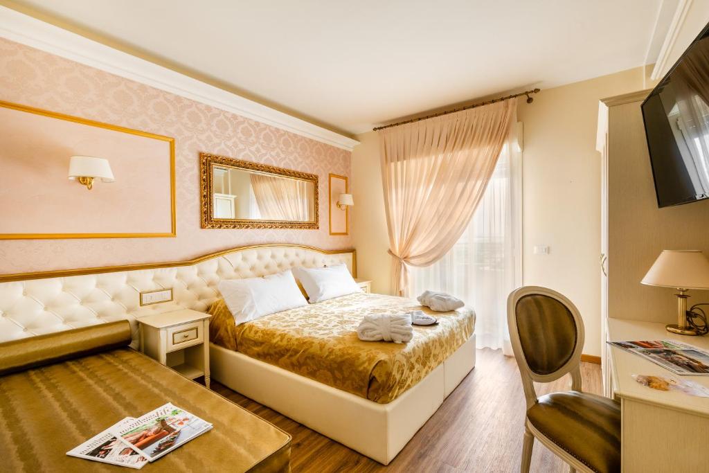 Postel nebo postele na pokoji v ubytování Hotel Mazzanti