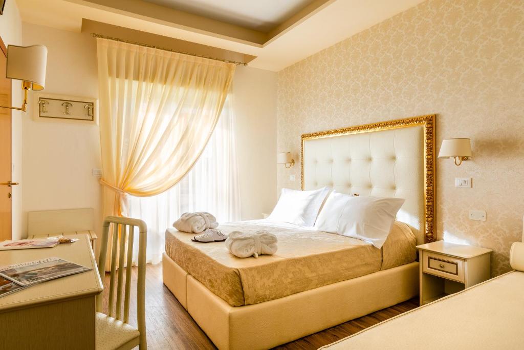 Postel nebo postele na pokoji v ubytování Hotel Mazzanti