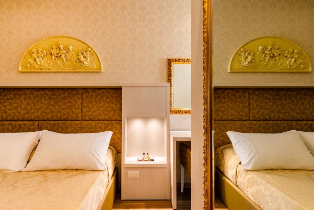 Postel nebo postele na pokoji v ubytování Hotel Mazzanti