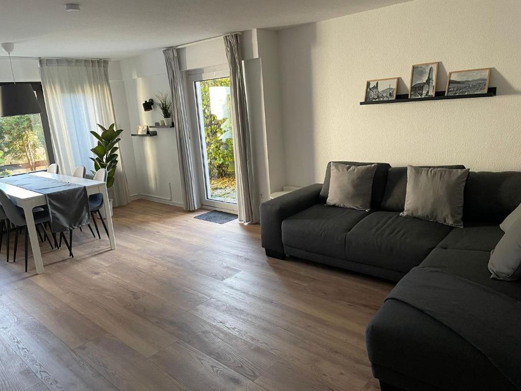 a living room with a couch and a table at Ferienwohnung di Simoni in Bad Laasphe