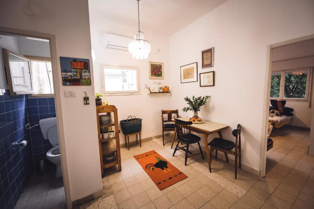 a kitchen and dining room with a table and a bathroom at Hillel 48 Charming Apartment in Haifa