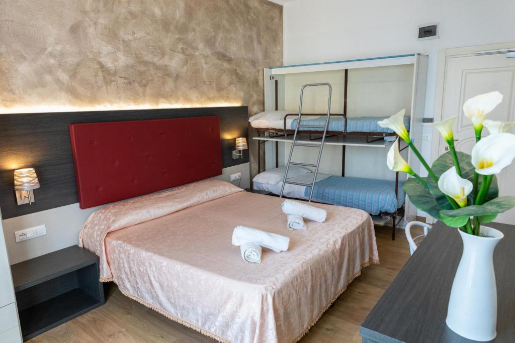 Postel nebo postele na pokoji v ubytování Hotel Verdi