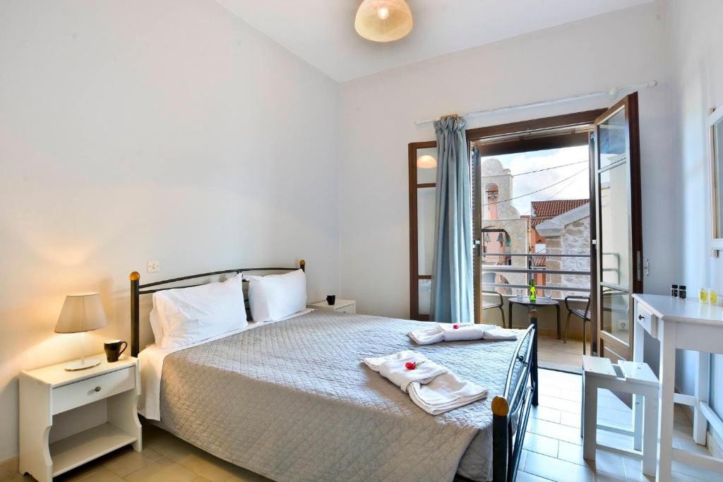 A bed or beds in a room at Kerkyra Apartments