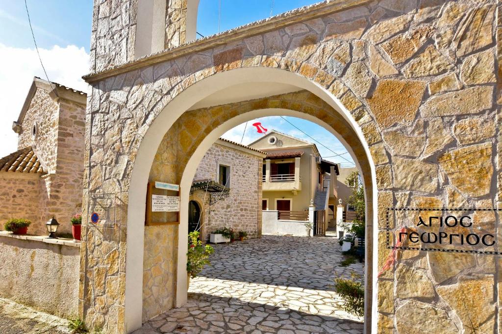 an entrance to a stone building with an archway at Kerkyra Apartments in Roda