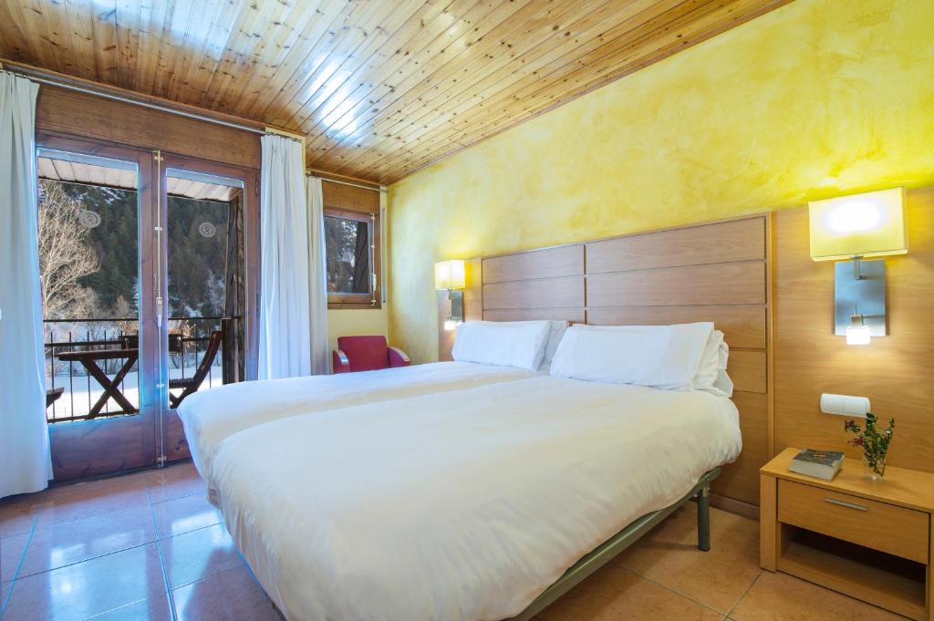 Postel nebo postele na pokoji v ubytování Pierre & Vacances Aparthotel La Tulipa