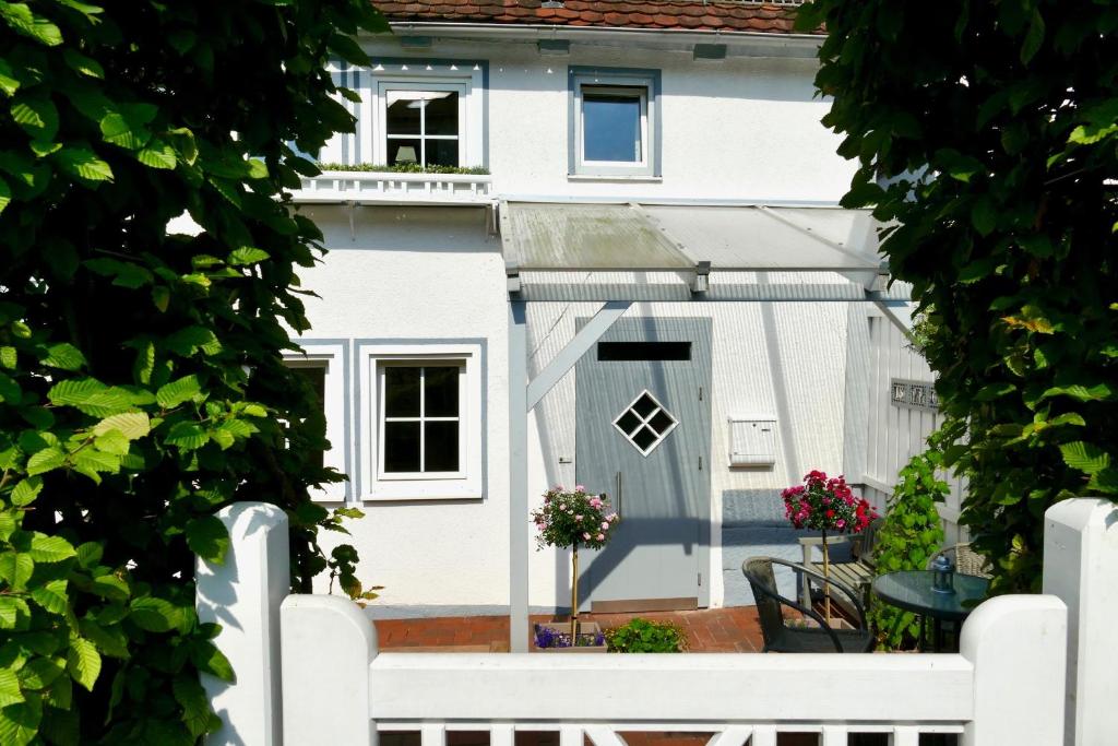 a white fence in front of a white house at Ferienhaus Landhaus Am Hirtzborn in Marbach