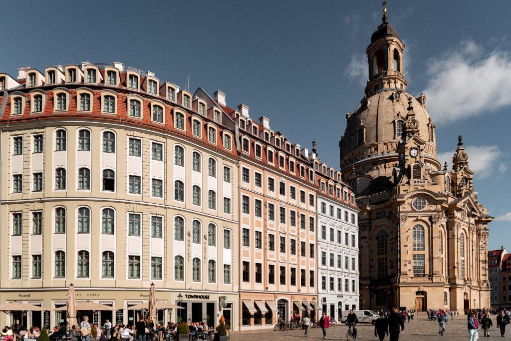 a large building with a clock on the front of it at Townhouse Dresden in Dresden