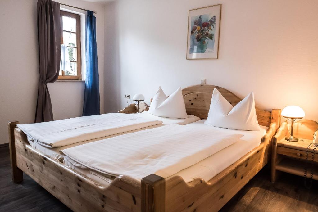 a large wooden bed in a room with a window at Marktplatzhotel - Restaurant Tafelspitz in Weinheim