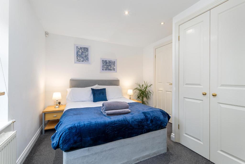 Un dormitorio con una cama grande con una manta azul. en City Centre Charming 2 Bed Lovely Apartment-Snugstaff, en Lincoln