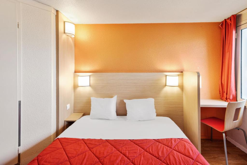 a hotel room with a bed and a desk at Premiere Classe Fontenay Tresigny in Fontenay-Trésigny