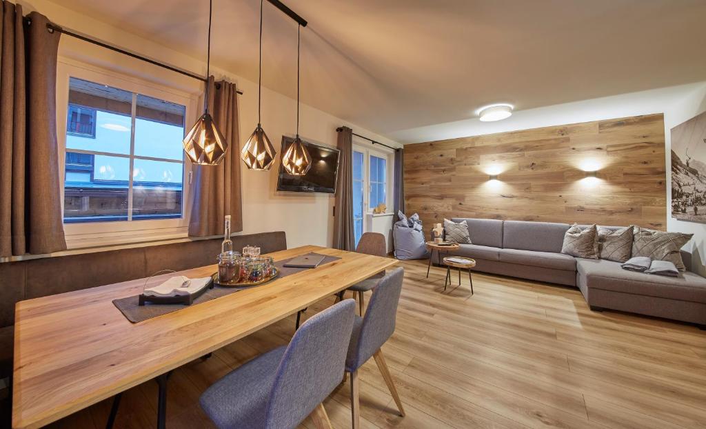 a living room with a table and a couch at Appartement Iglsberg Top 4 in Saalbach-Hinterglemm
