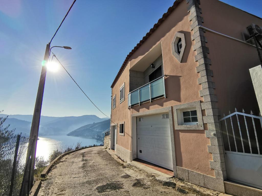 ein Haus auf einem Hügel mit Blick auf das Wasser in der Unterkunft Vivenda Portela in Covelinhas
