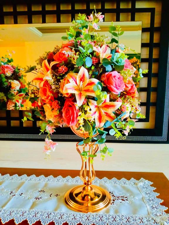 a vase with flowers in it on a table at Hotel Pousada Irmaos Freyhardt in Rio de Janeiro