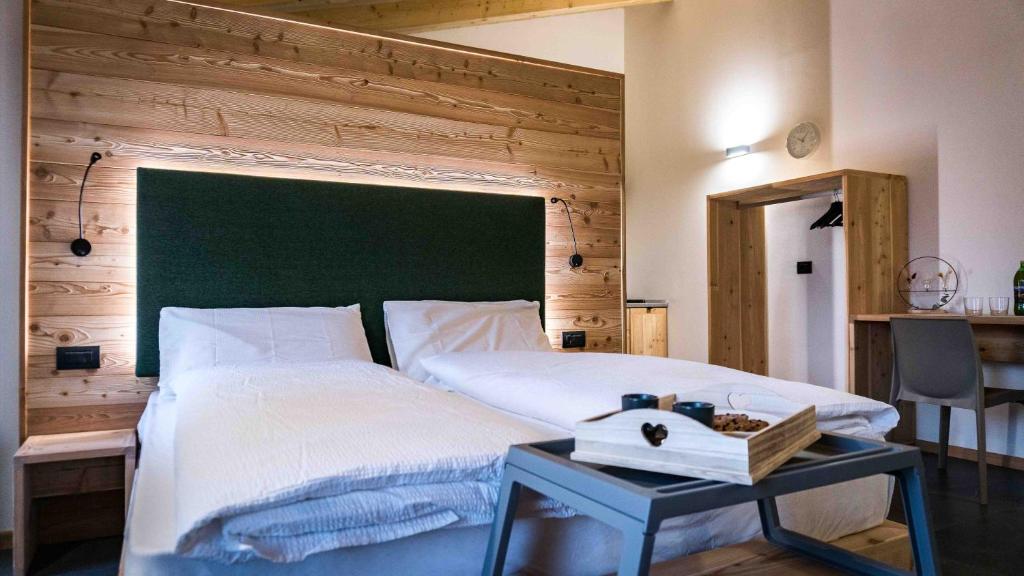 a bedroom with a large bed with a green headboard at ALPS LOVER in Campodenno
