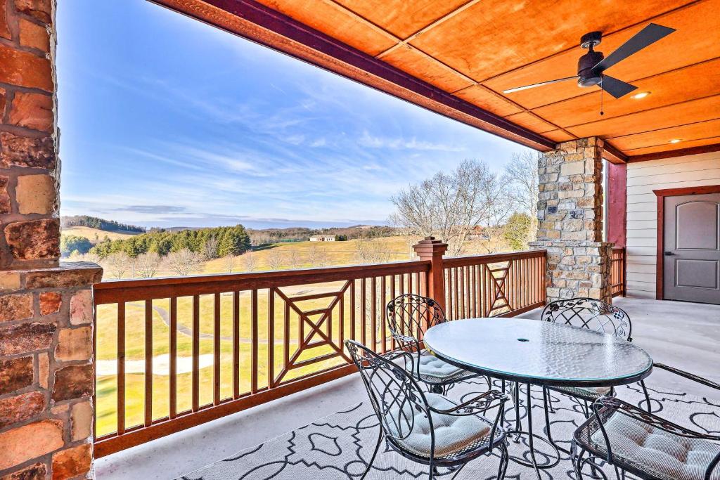 a patio with a table and chairs on a balcony at Laurel Fork Condo on Olde Mill Golf Course! in Ararat