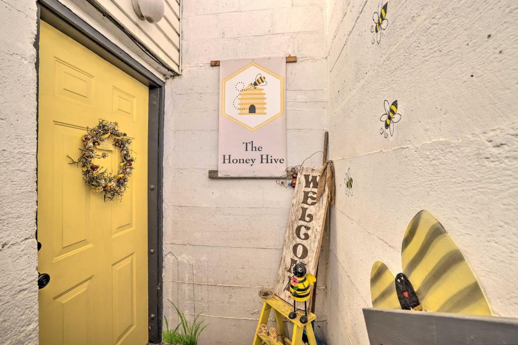 a yellow door and a sign on a building at Cozy and Vintage Cedar City Apartment with Fire Pit! in Cedar City